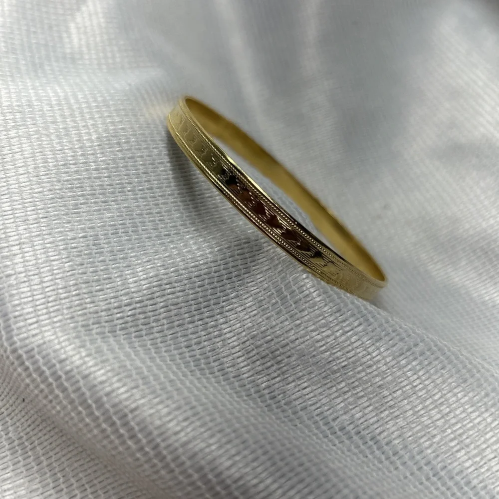 Gold Tone Heart Engraved Bangle Bracelet Measuring 2 3/4 Inches Across
